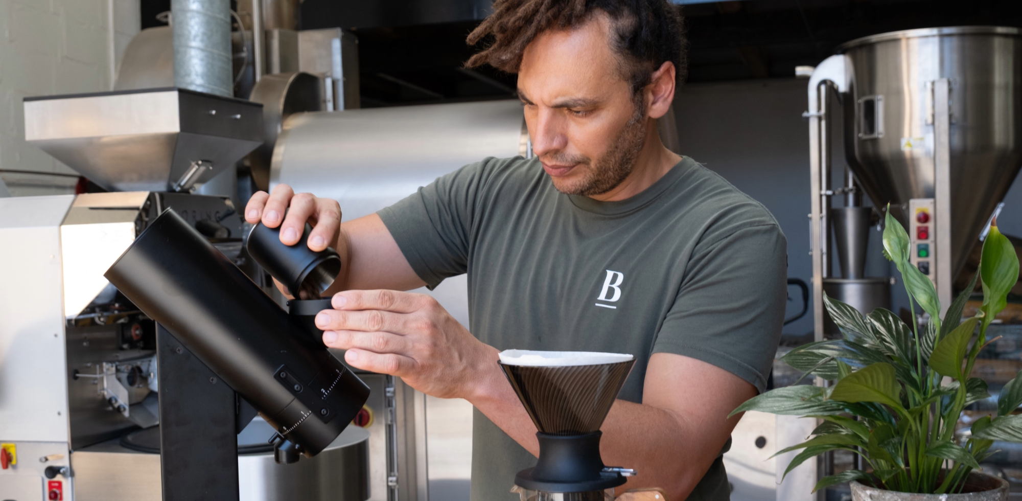 Danny using an Orbit to grind coffee for a pour over 